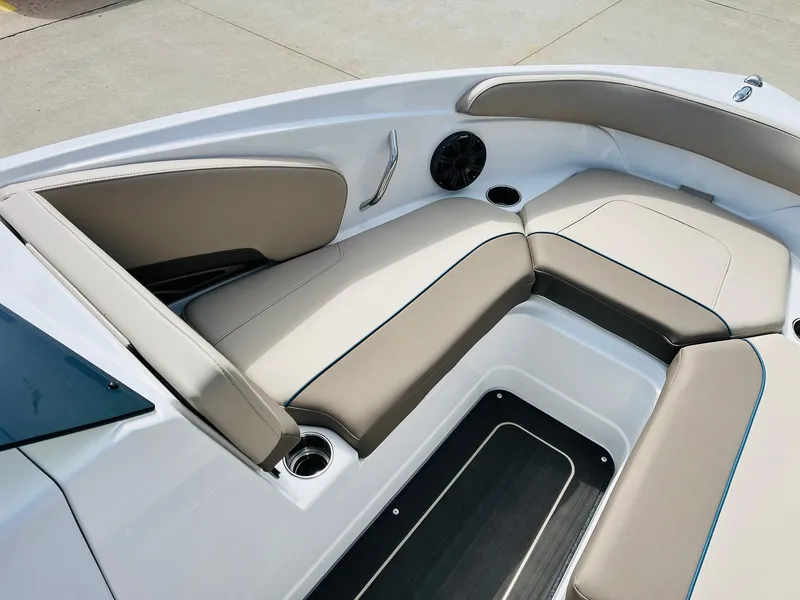 Slide: The Image of 2024 Tahoe 210 S Limited boat interior with beige seating and cup holders. - 12