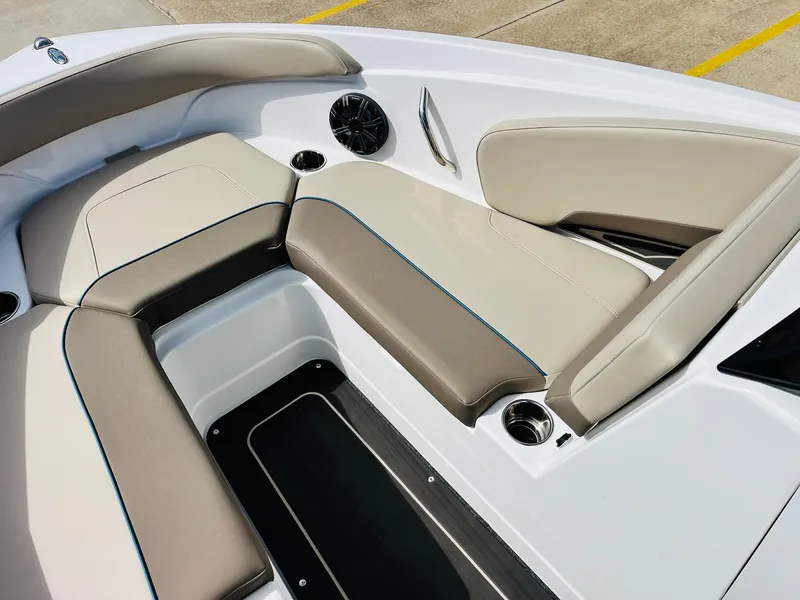 Slide: The Image of 2024 Tahoe 210 S Limited boat interior with beige seating and cup holders. - 13