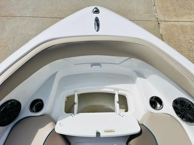Slide: The Image of 2024 Tahoe 210 S Limited boat bow with open storage compartment and speakers. - 16