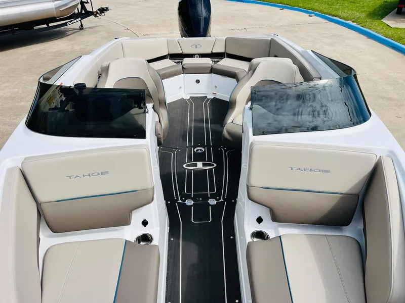 Slide: The Image of 2024 Tahoe 210 S Limited boat interior with beige seating and sleek design. - 17