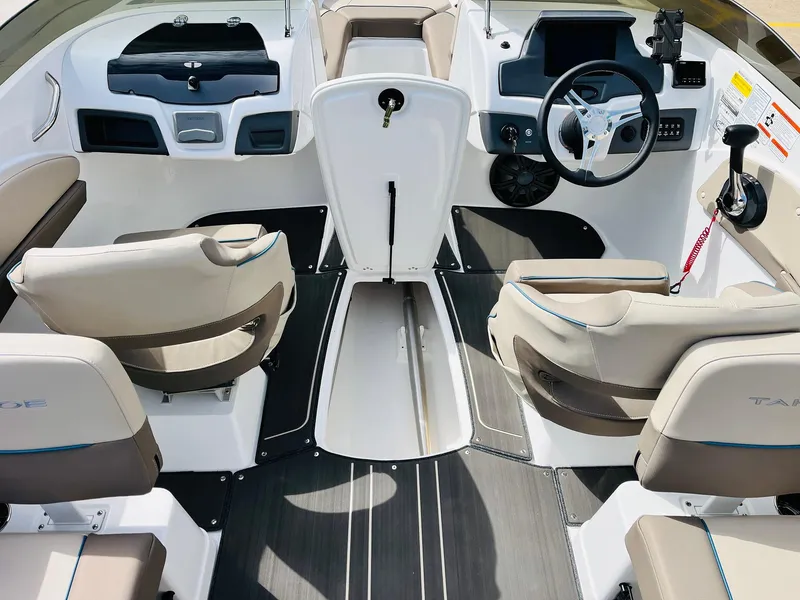 Slide: The Image of 2024 Tahoe 210 S Limited boat interior with modern seating and steering console. - 19