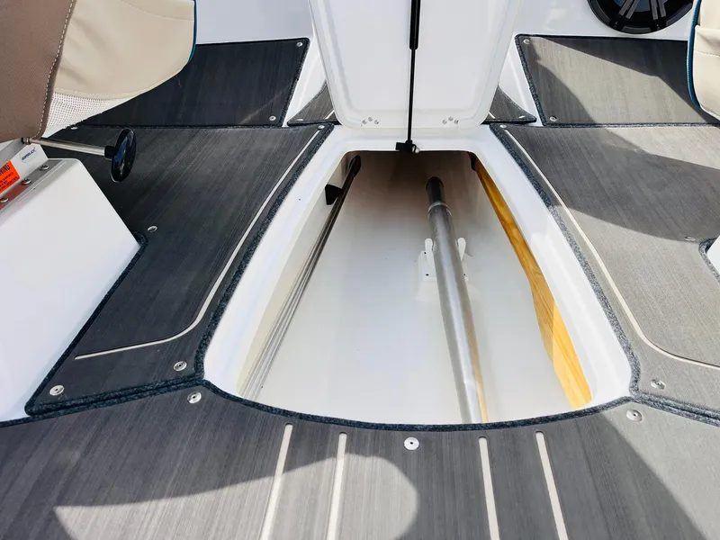 Slide: The Image of 2024 Tahoe 210 S Limited boat interior storage compartment with sleek design and ample space. - 20