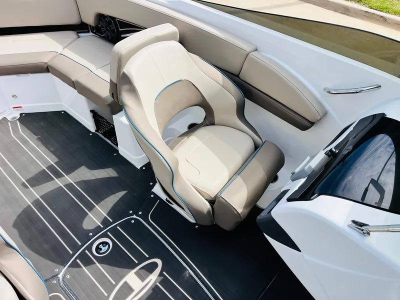 Slide: The Image of 2024 Tahoe 210 S Limited boat interior with beige seating and sleek design. - 22