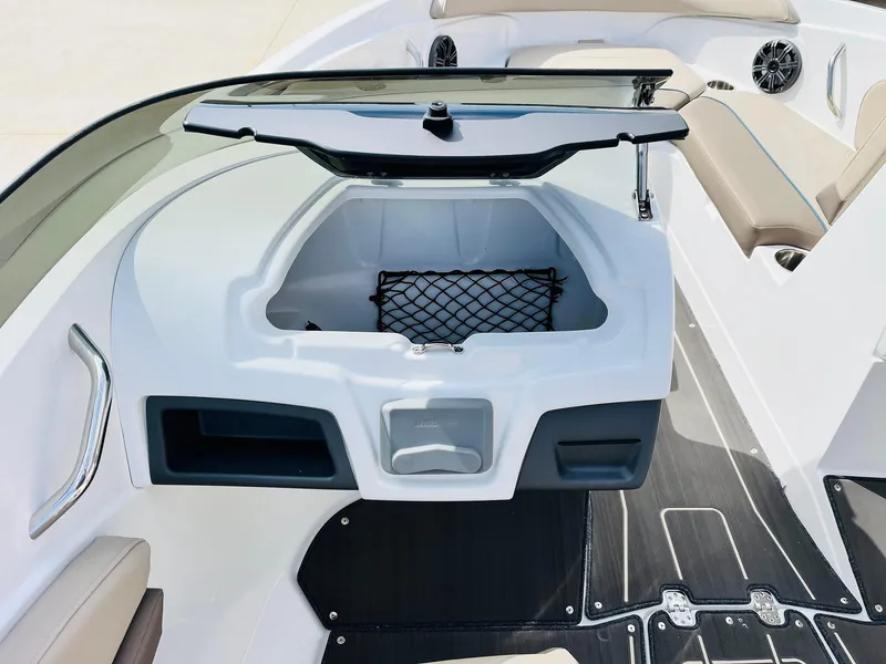 Slide: The Image of 2024 Tahoe 210 S Limited boat interior with open storage compartment and seating. - 24