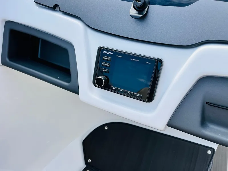 Slide: The Image of 2024 Tahoe 210 S Limited boat dashboard with a modern control panel. - 25