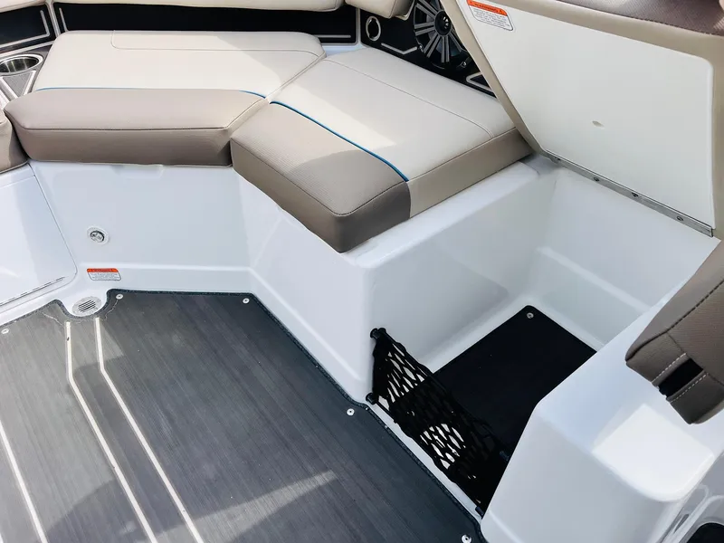 Slide: The Image of 2024 Tahoe 210 S Limited boat interior with seating and storage compartment. - 29