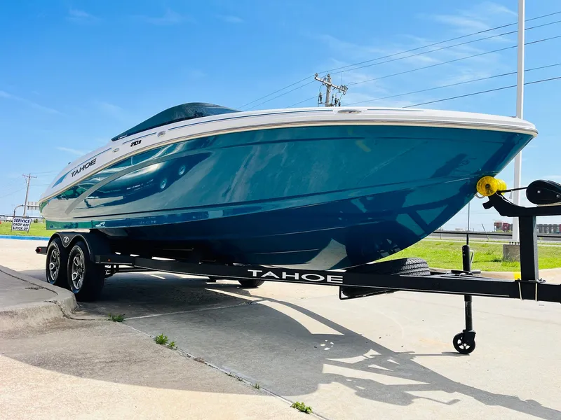 Slide: The Image of 2024 Tahoe 210 S Limited boat on trailer, vibrant blue hull, sunny day. - 3