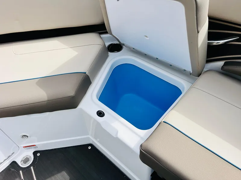 Slide: The Image of 2024 Tahoe 210 S Limited boat seating with storage compartment open. - 30