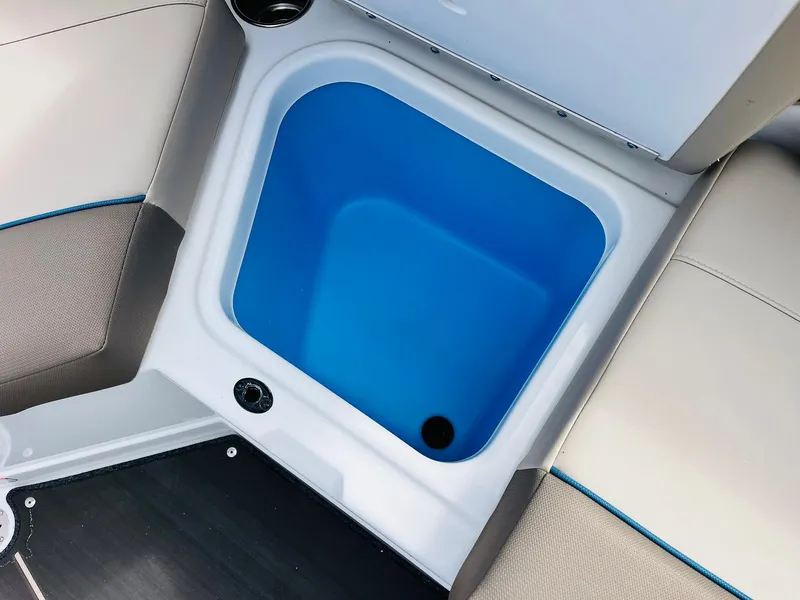 Slide: The Image of 2024 Tahoe 210 S Limited boat storage compartment with blue interior. - 31