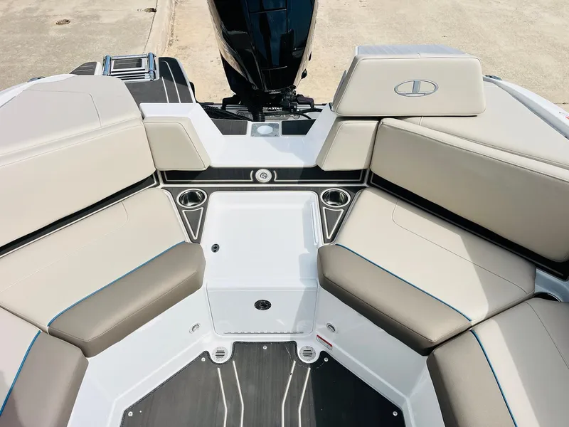 Slide: The Image of 2024 Tahoe 210 S Limited boat interior with beige seating and cup holders. - 33
