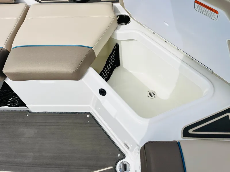 Slide: The Image of 2024 Tahoe 210 S Limited boat storage compartment with cushioned seating. - 34