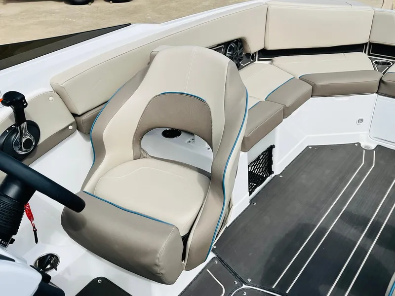 Slide: The Image of 2024 Tahoe 210 S Limited boat interior with beige seating and modern design. - 39