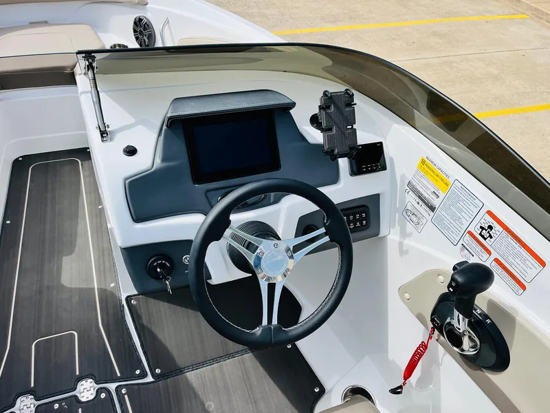 Slide: The Image of 2024 Tahoe 210 S Limited boat dashboard with steering wheel and control panel. - 41