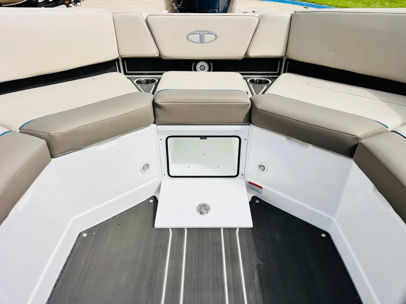 Slide: The Image of 2024 Tahoe 210 S Limited boat interior with cushioned seating and storage compartment. - 44