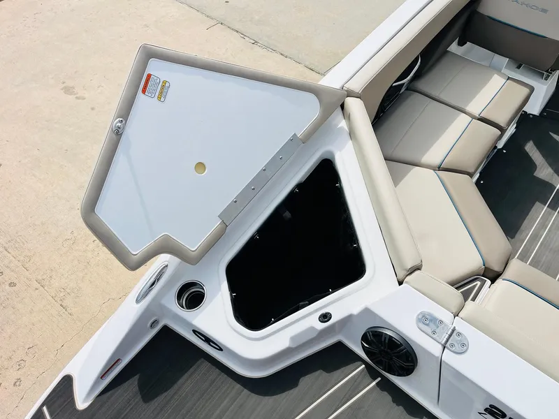 Slide: The Image of 2024 Tahoe 210 S Limited boat interior with open storage compartment and seating. - 46