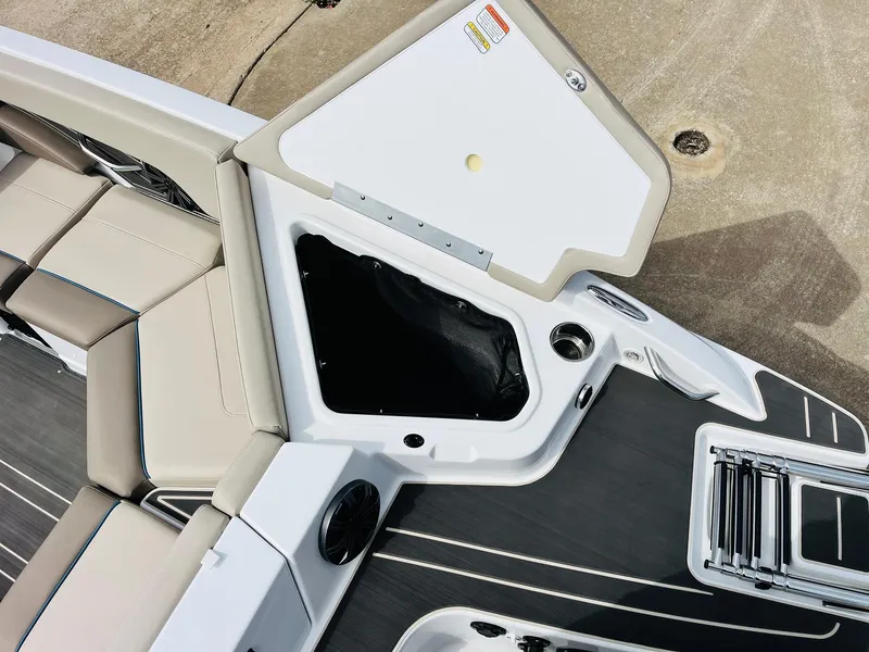 Slide: The Image of 2024 Tahoe 210 S Limited boat interior with open storage compartment and seating. - 48