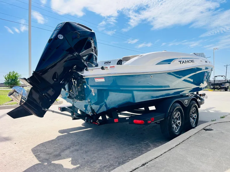 Slide: The Image of 2024 Tahoe 210 S Limited boat on trailer, blue and white design, outdoor setting. - 6
