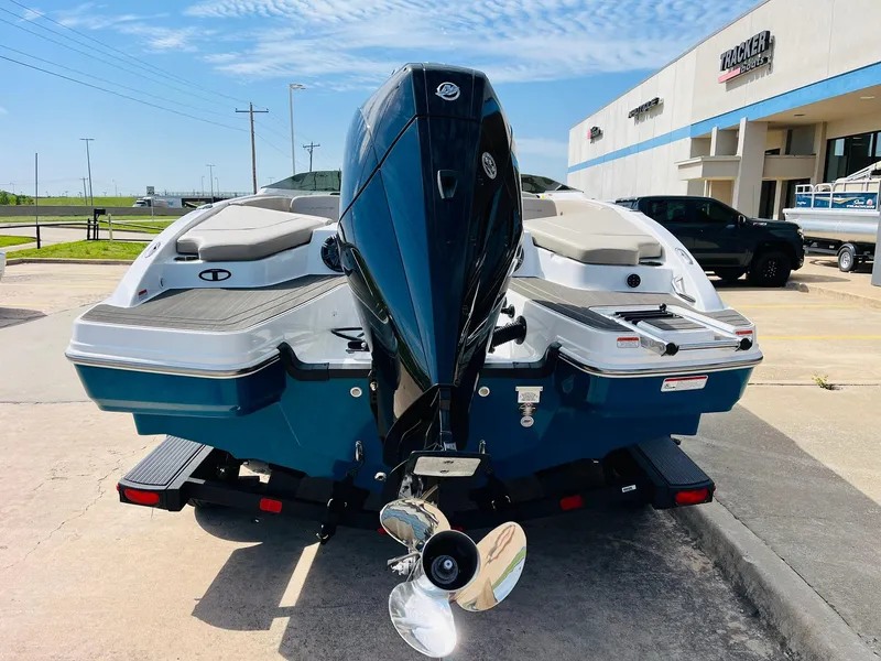 Slide: The Image of 2024 Tahoe 210 S Limited boat with outboard motor, parked on a trailer. - 7