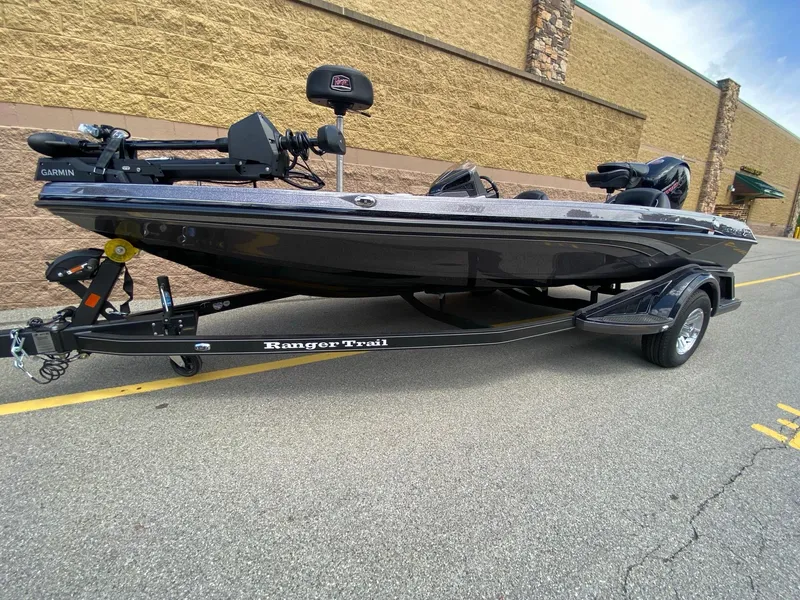 Slide: The Image of 2025 Ranger Z518 Cup-Equipped boat on trailer, parked outdoors. - 2
