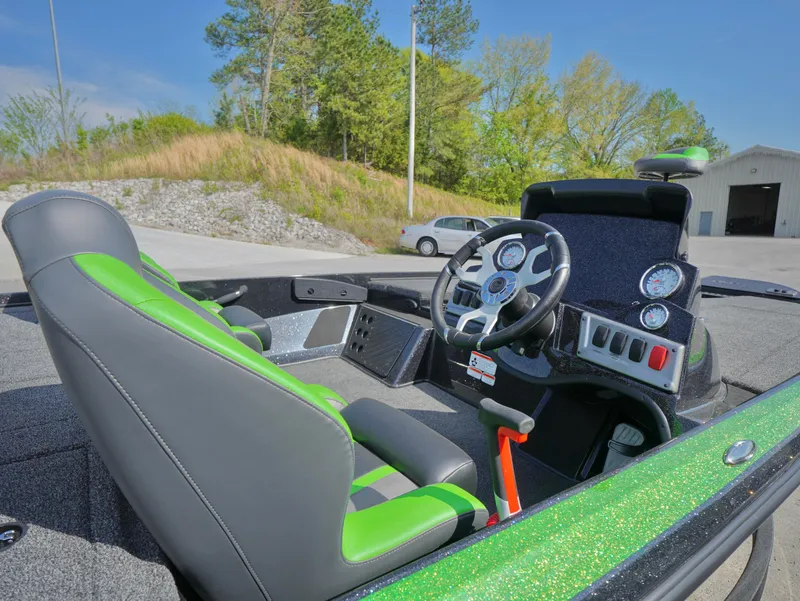 Slide: The Image of Interior of 2025 Nitro Z18 boat with green and black seating, steering wheel, and dashboard. - 5