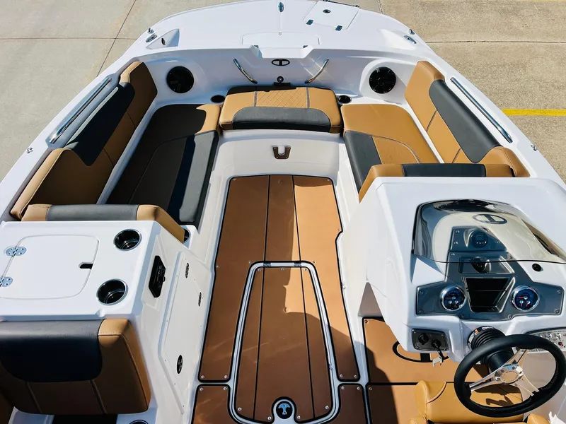 Slide: The Image of 2024 Tahoe 1950 boat interior with tan and black seating, modern dashboard, and spacious layout. - 11