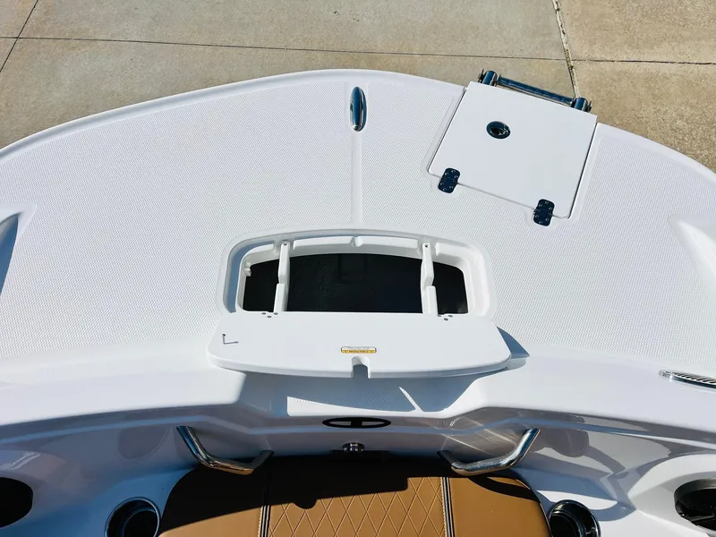 Slide: The Image of 2024 Tahoe 1950 boat deck with storage compartments and sleek design. - 13