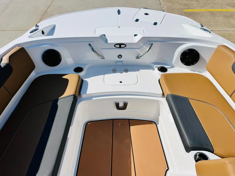 Slide: The Image of 2024 Tahoe 1950 boat interior with tan and black seating, modern design, and spacious layout. - 17