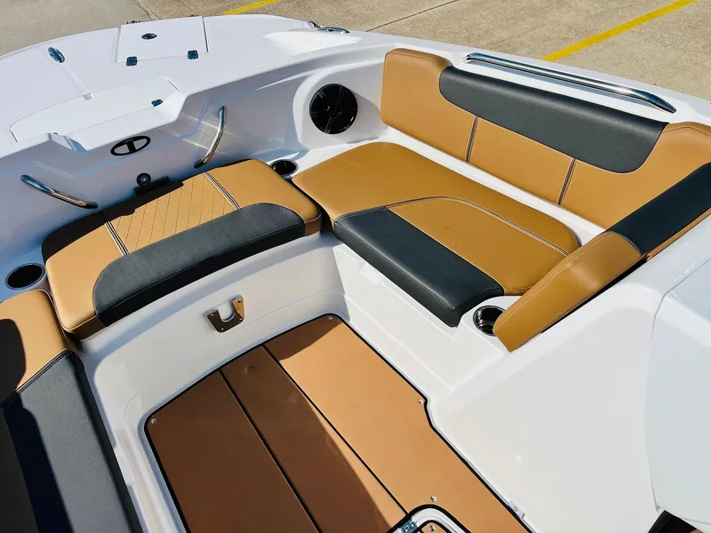 Slide: The Image of 2024 Tahoe 1950 boat interior with tan and black seating, cup holders, and sleek design. - 18