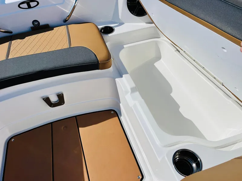 Slide: The Image of 2024 Tahoe 1950 boat interior with storage compartment and cushioned seating. - 19