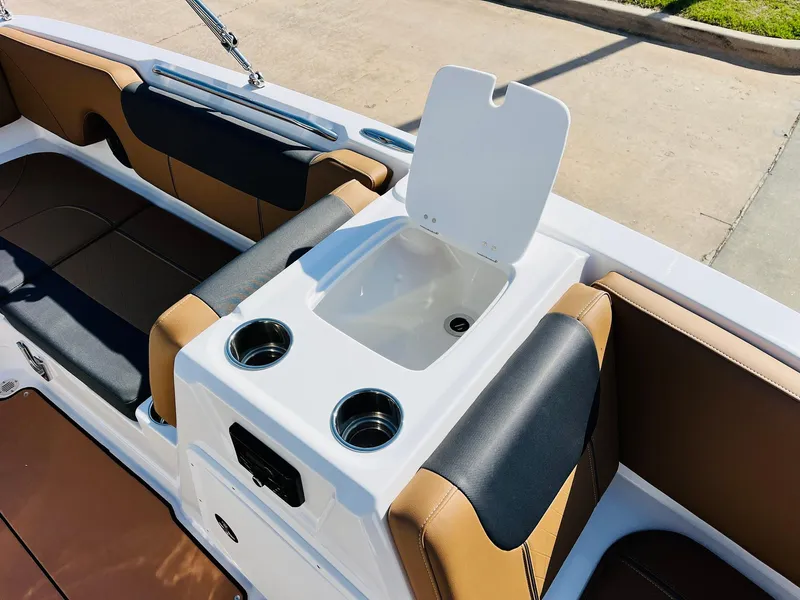 Slide: The Image of 2024 Tahoe 1950 boat interior with sink and cup holders, featuring brown and black seating. - 22