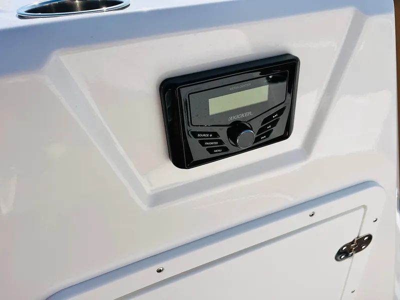 Slide: The Image of 2024 Tahoe 1950 boat dashboard with modern audio system. - 23