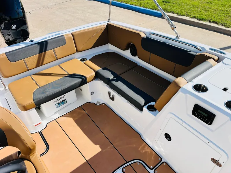 Slide: The Image of 2024 Tahoe 1950 boat interior with tan and black seating, cup holders, and spacious layout. - 25