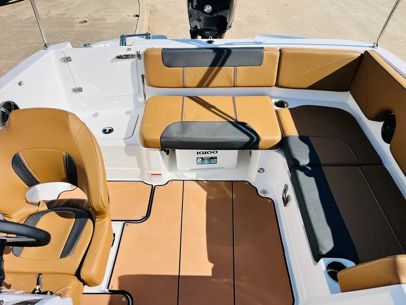 Slide: The Image of 2024 Tahoe 1950 boat interior with tan and black seating, modern design. - 29