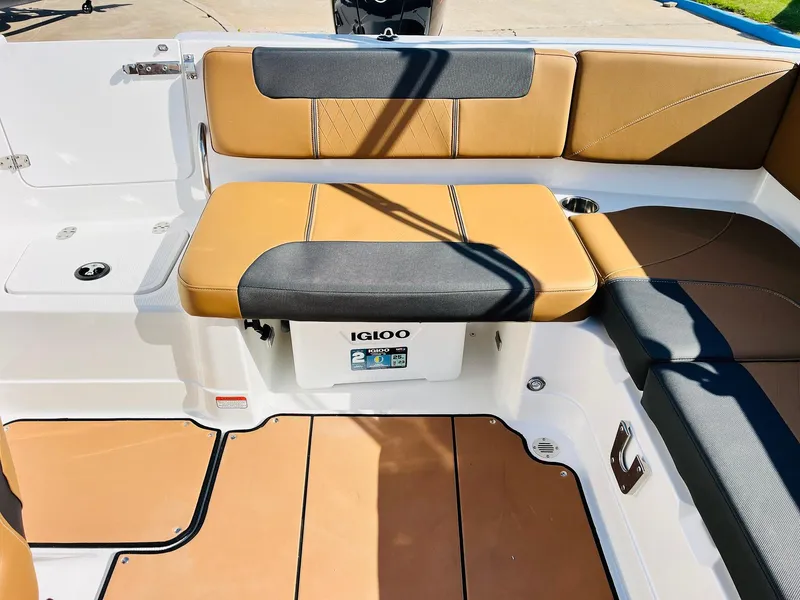 Slide: The Image of 2024 Tahoe 1950 boat interior with tan and black seating, featuring an Igloo cooler. - 31