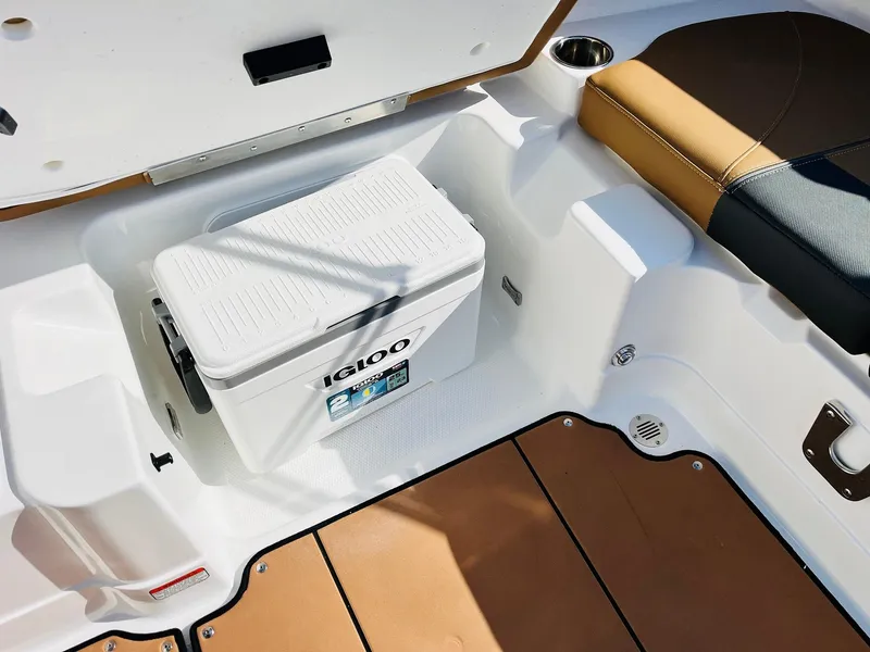 Slide: The Image of 2024 Tahoe 1950 boat interior with Igloo cooler and cushioned seating. - 32