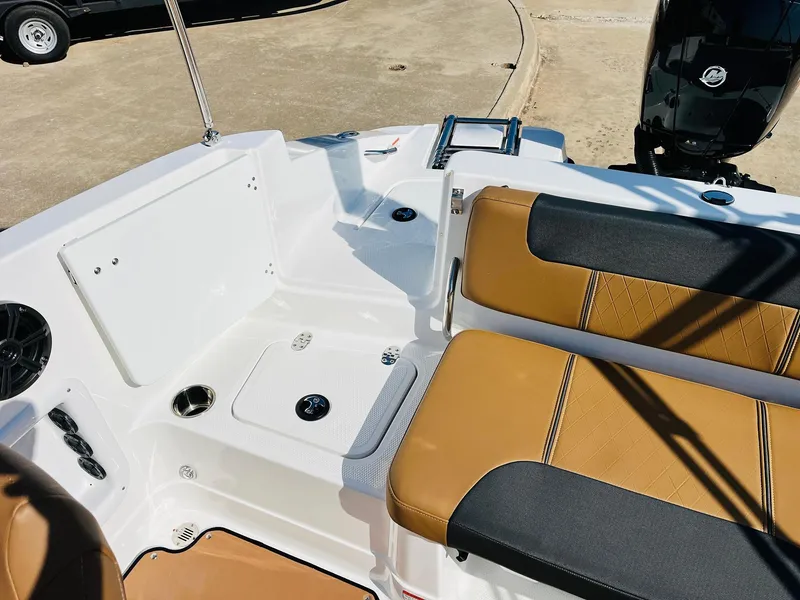 Slide: The Image of Interior of 2024 Tahoe 1950 boat with tan and black seating, white deck, and cup holders. - 35