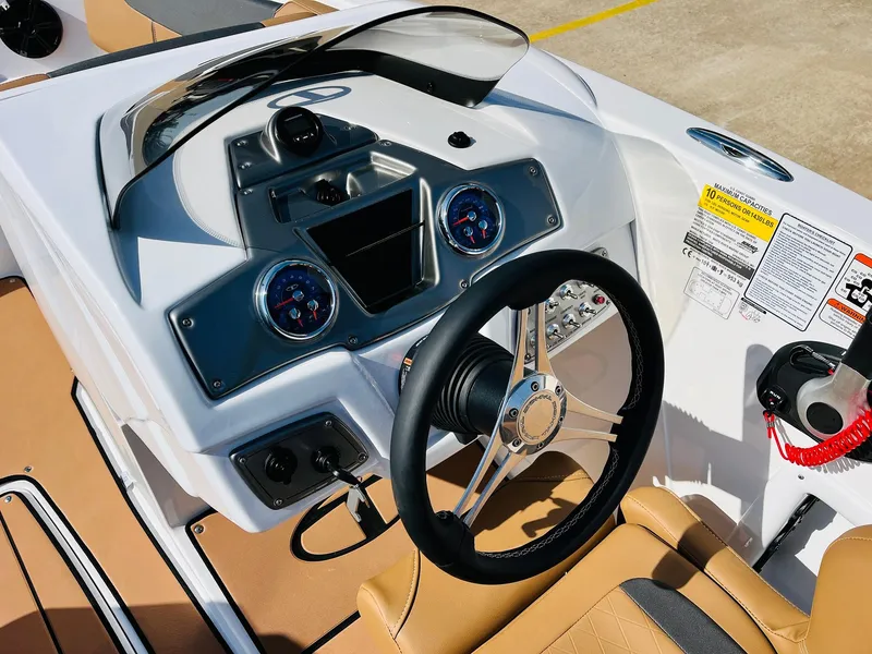 Slide: The Image of Dashboard of a 2024 Tahoe 1950 boat with steering wheel and gauges. - 40