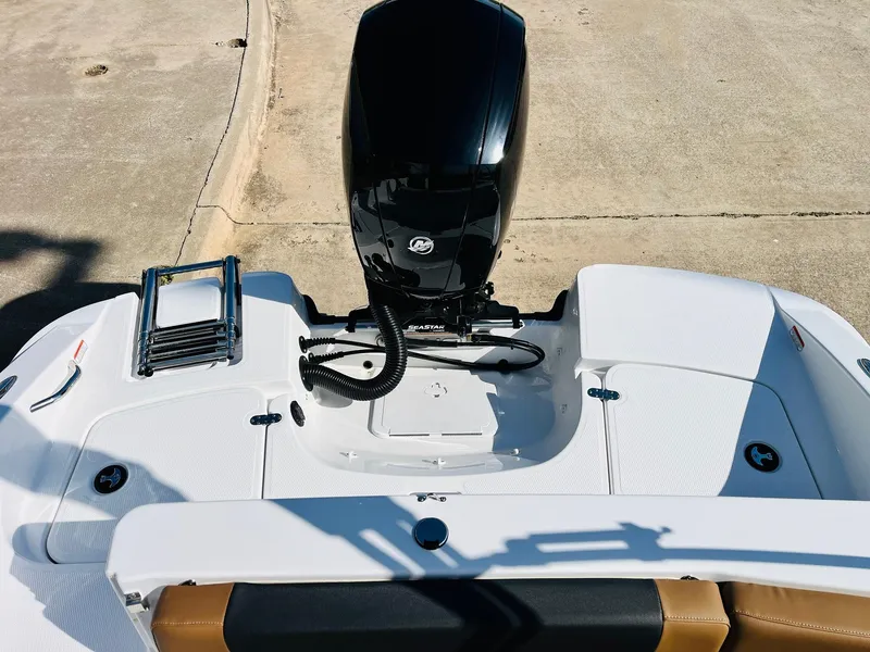 Slide: The Image of 2024 Tahoe 1950 boat with outboard motor and swim platform, featuring a ladder. - 43