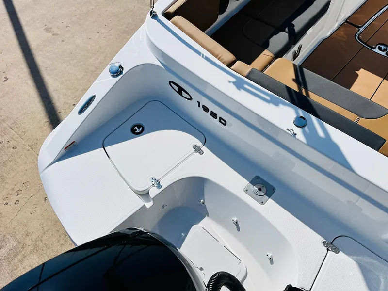 Slide: The Image of 2024 Tahoe 1950 boat interior with seating and storage compartments. - 44