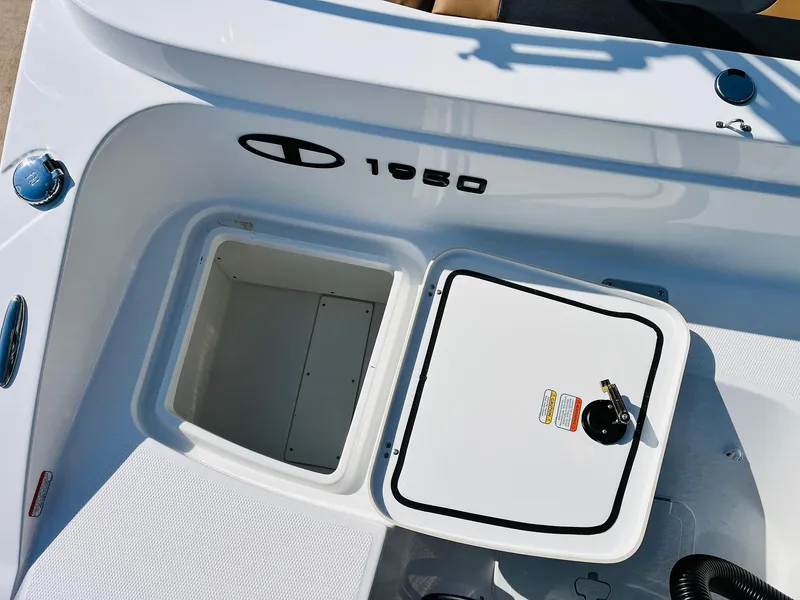 Slide: The Image of 2024 Tahoe 1950 boat storage compartment with secure latch and sleek design. - 45