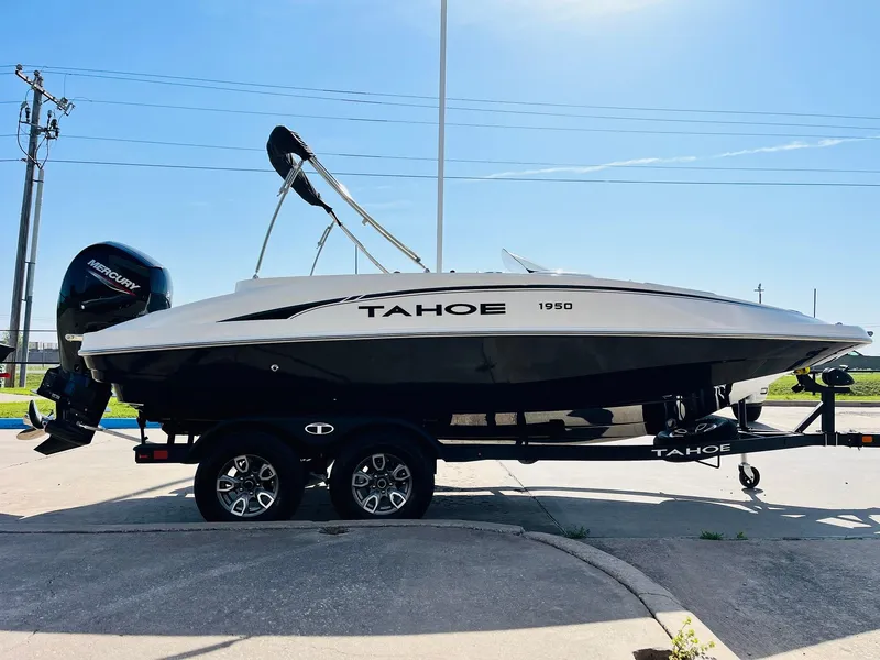 Slide: The Image of 2024 Tahoe 1950 boat on trailer, side view, outdoors, sunny day. - 5