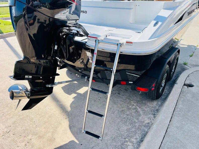 Slide: The Image of 2024 Tahoe 1950 boat with ladder and outboard motor on trailer. - 9