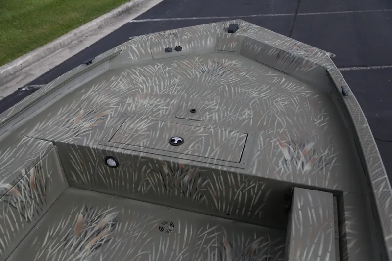 Slide: The Image of 2025 Tracker Grizzly 1654 T Sportsman boat with camouflage pattern on deck. - 2