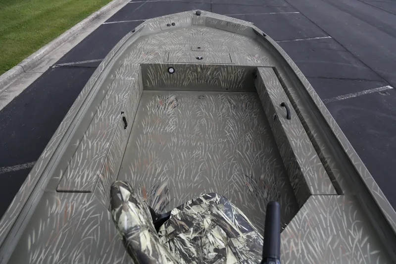 Slide: The Image of 2025 Tracker Grizzly 1654 T Sportsman boat with camouflage interior design. - 4