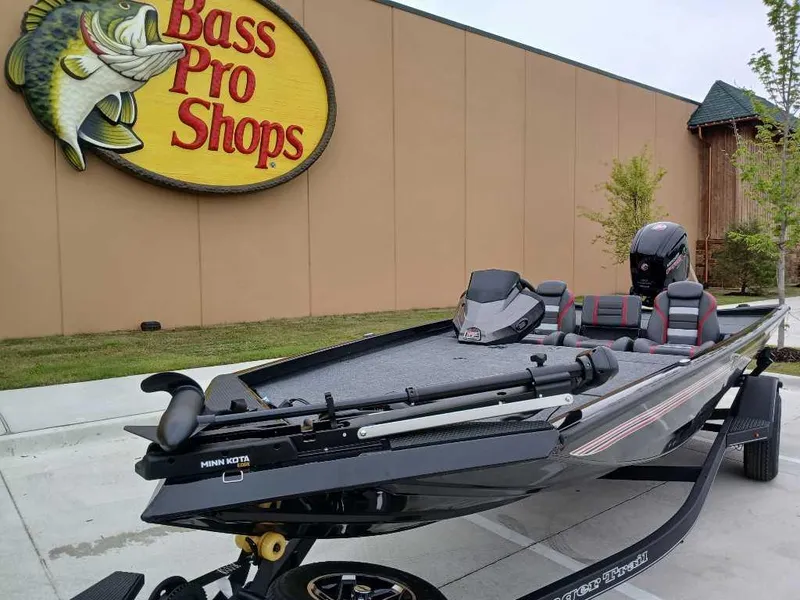 Slide: The Image of 2025 Ranger RT188 boat displayed outside Bass Pro Shops store. - 2