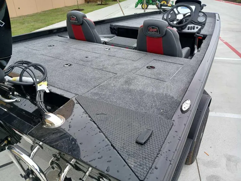 Slide: The Image of 2025 Ranger RT188 fishing boat with dual seats and spacious deck, parked outdoors. - 7