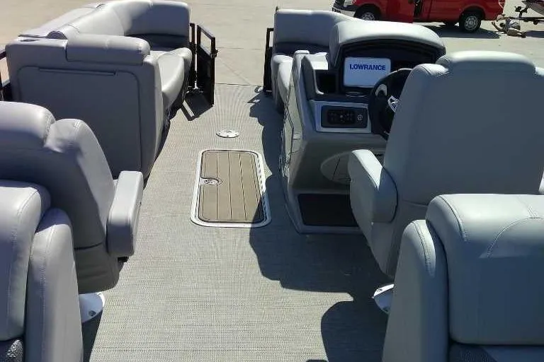 Slide: The Image of 2024 Regency 230 DL3 boat interior with gray seating and modern dashboard. - 3