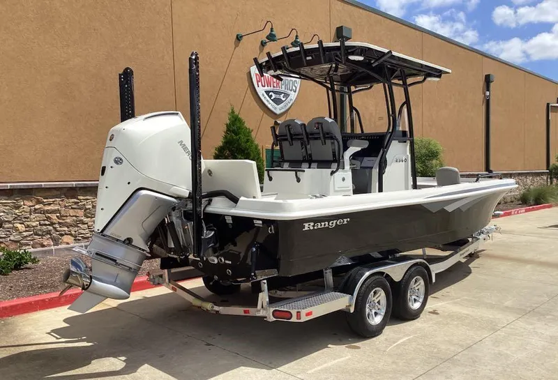 Slide: The Image of 2025 Ranger 2360 Bay boat on trailer, parked outdoors near a building. - 3