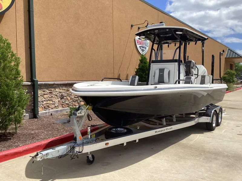 Slide: The Image of 2025 Ranger 2360 Bay boat on trailer, parked outdoors near a building. - 4