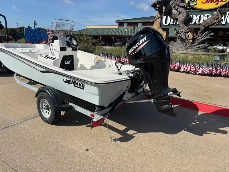 Slide: The Image of 2025 Mako Pro Skiff 15 CC boat with Mercury engine on trailer. - 2